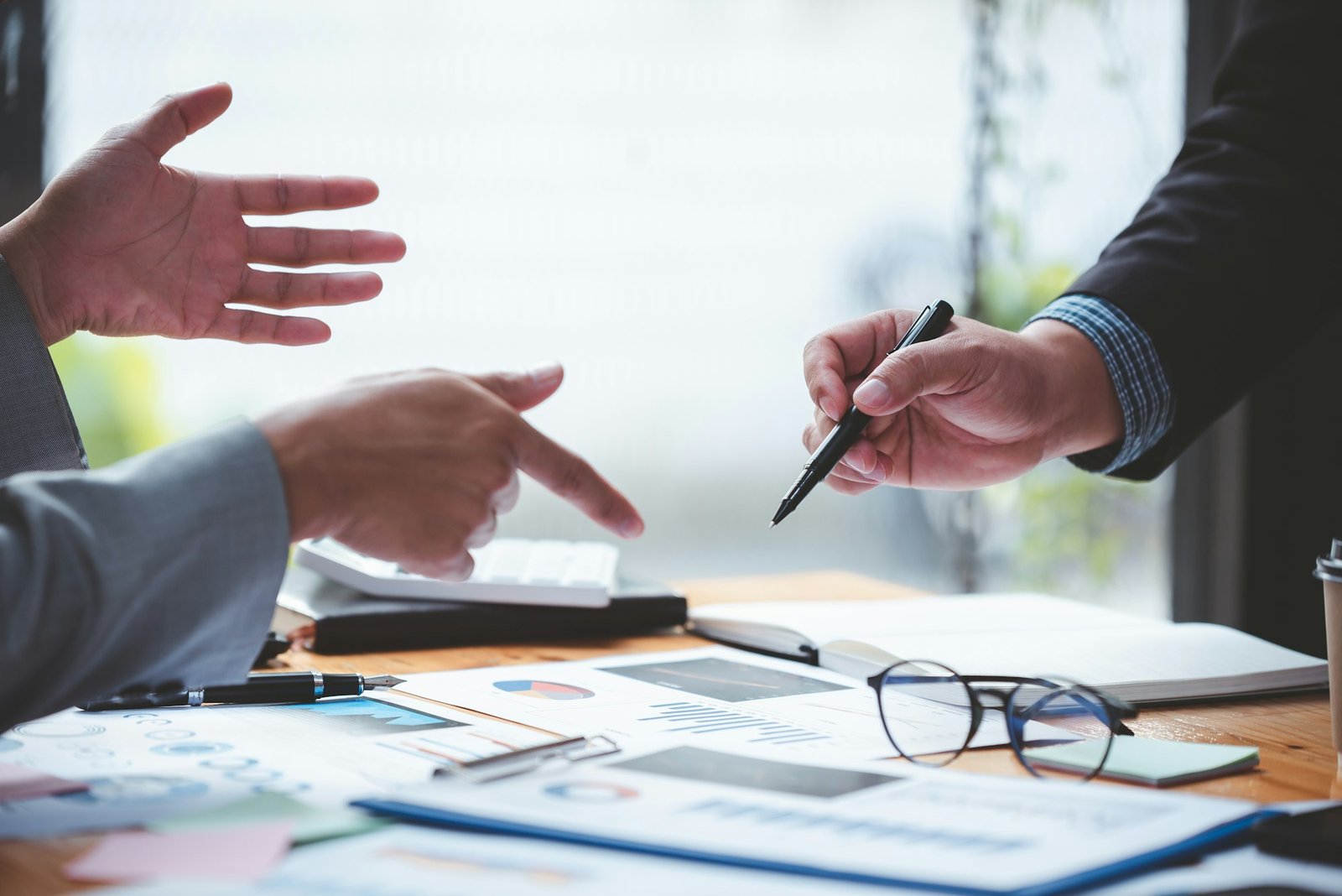 Businessmen meeting together to analyze project feasibility at office